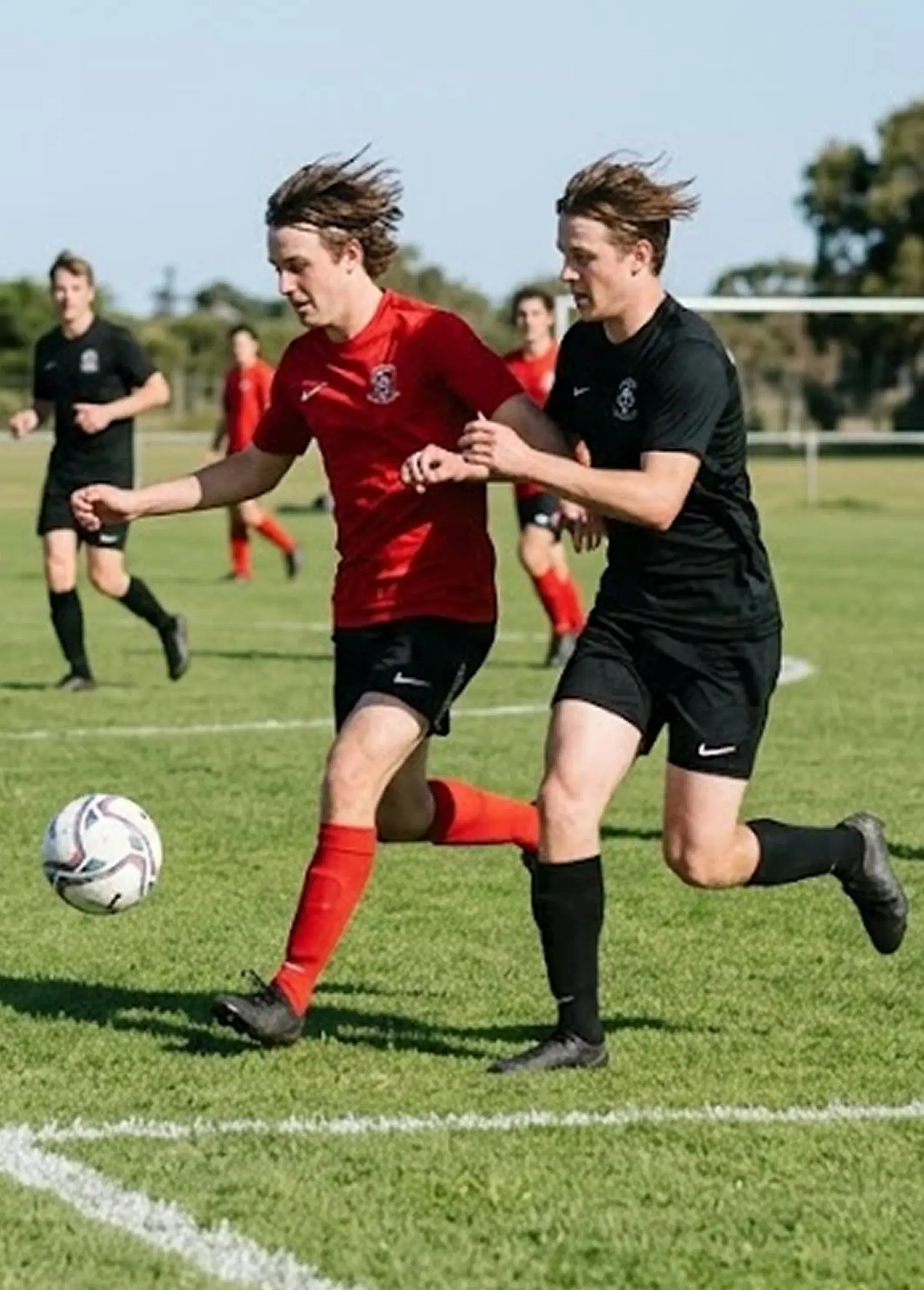 Soccer action shot - young players on young players on field