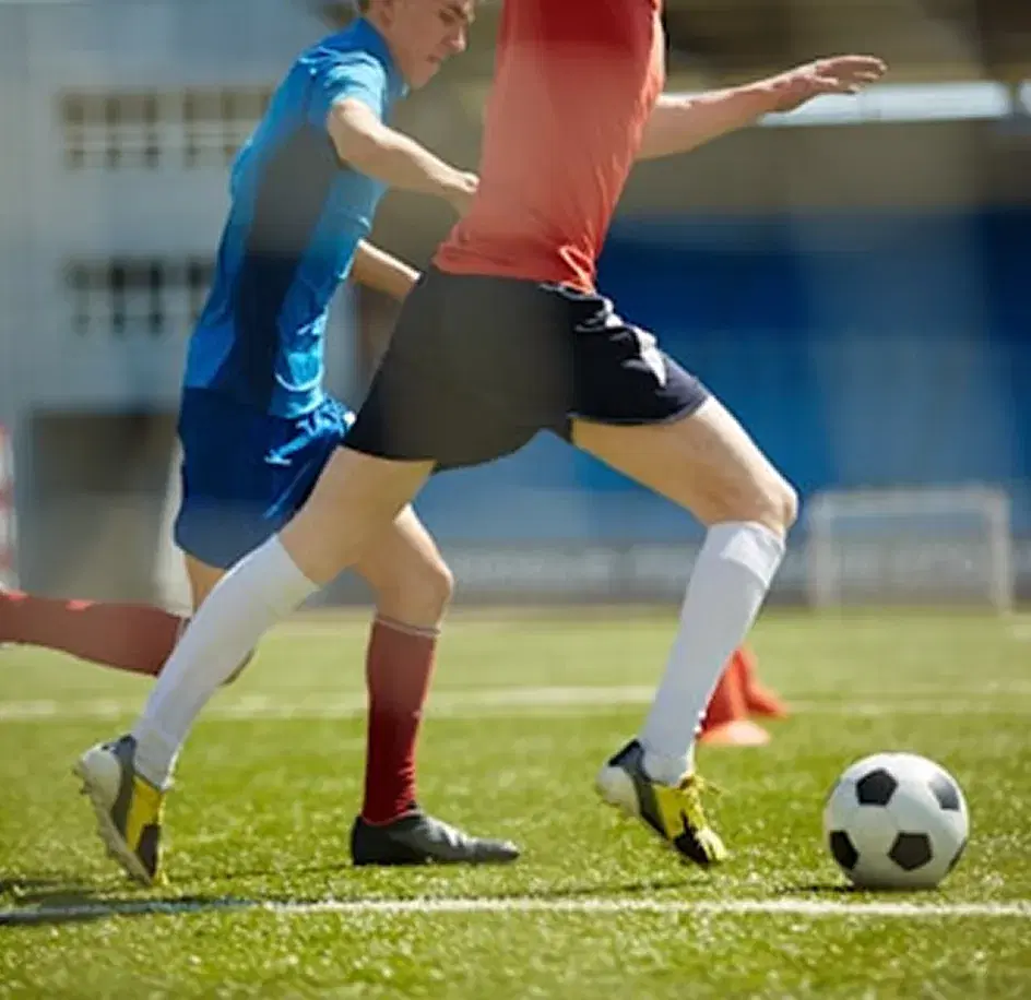 Players contesting the ball on turf