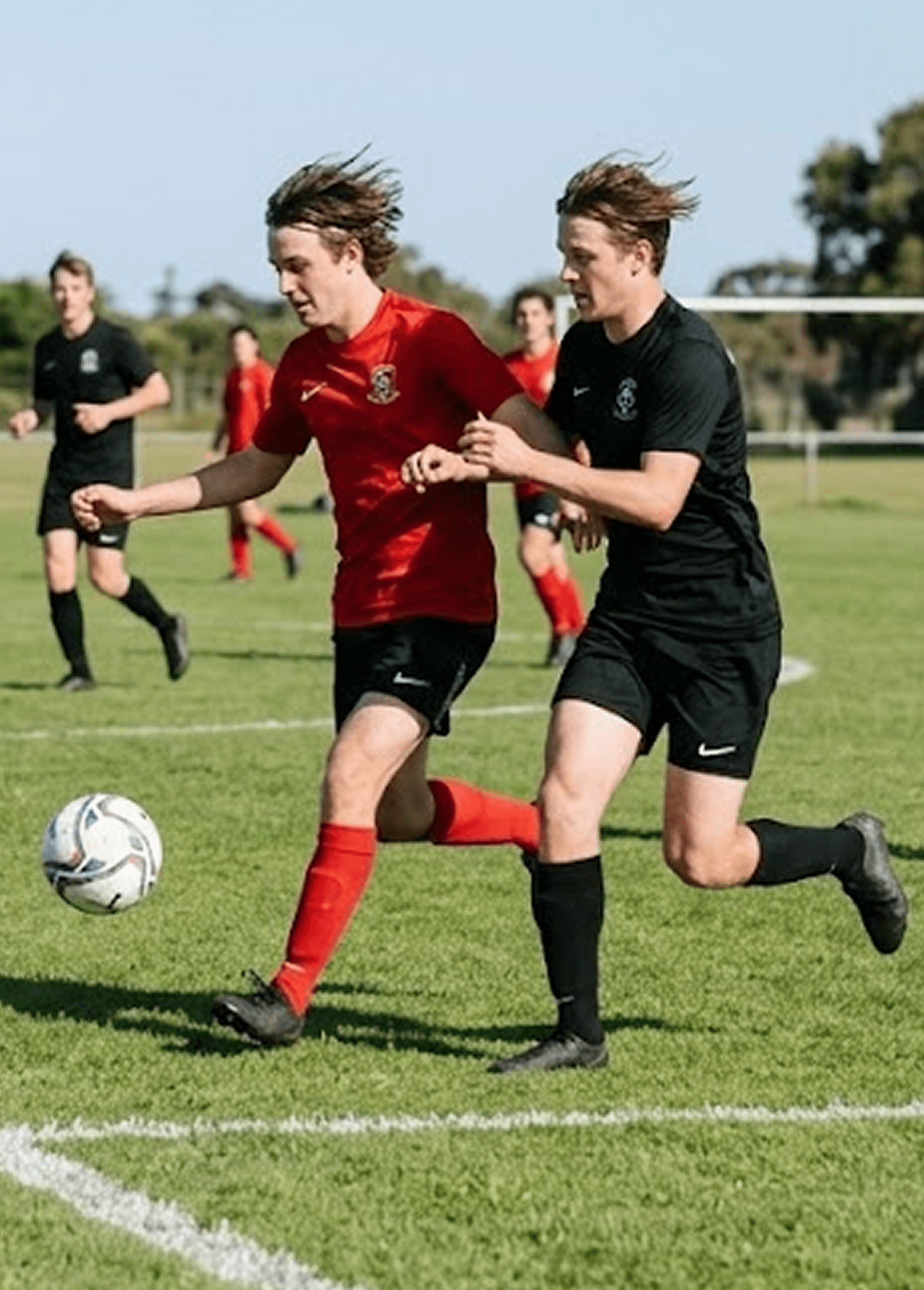 Soccer action shot - young players on green field