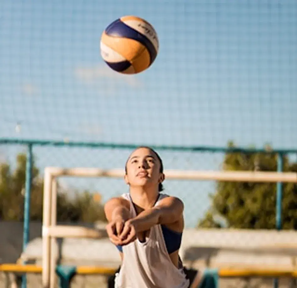 Athlete bumping a volleyball outdoors